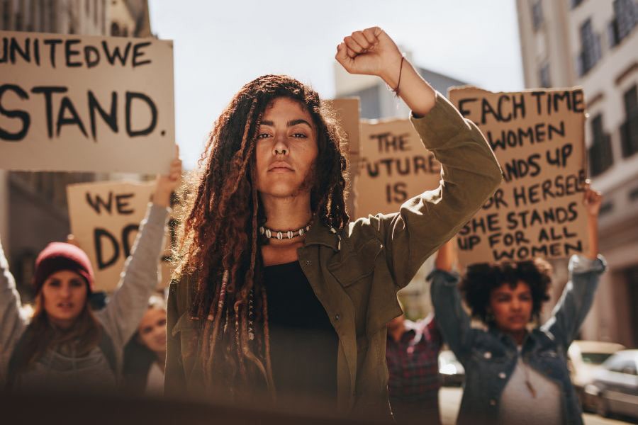 Inspirational women spearheading a diverse equality march on the street, advocating for gender and LGBTQ rights, embodying the spirit of inclusive feminism.